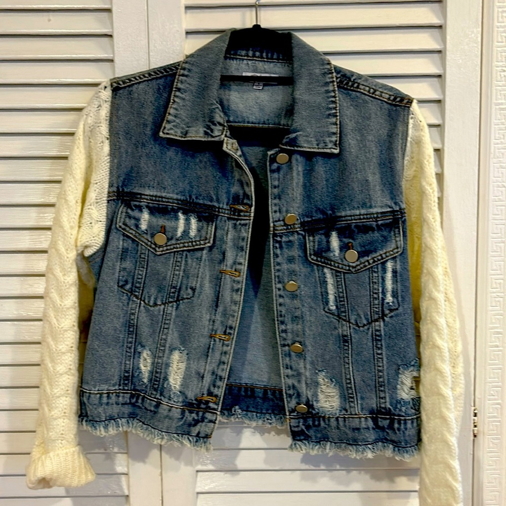 Polagram distressed denim jacket with sweater sleeves.